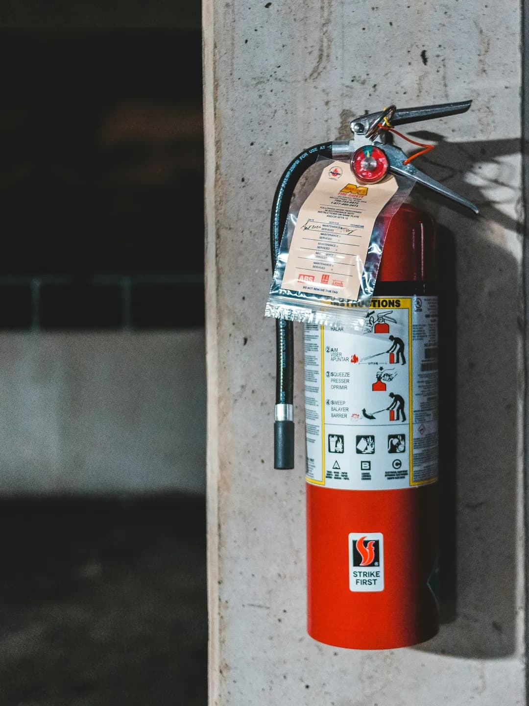 A serviced extinguisher with its dated inspection tag