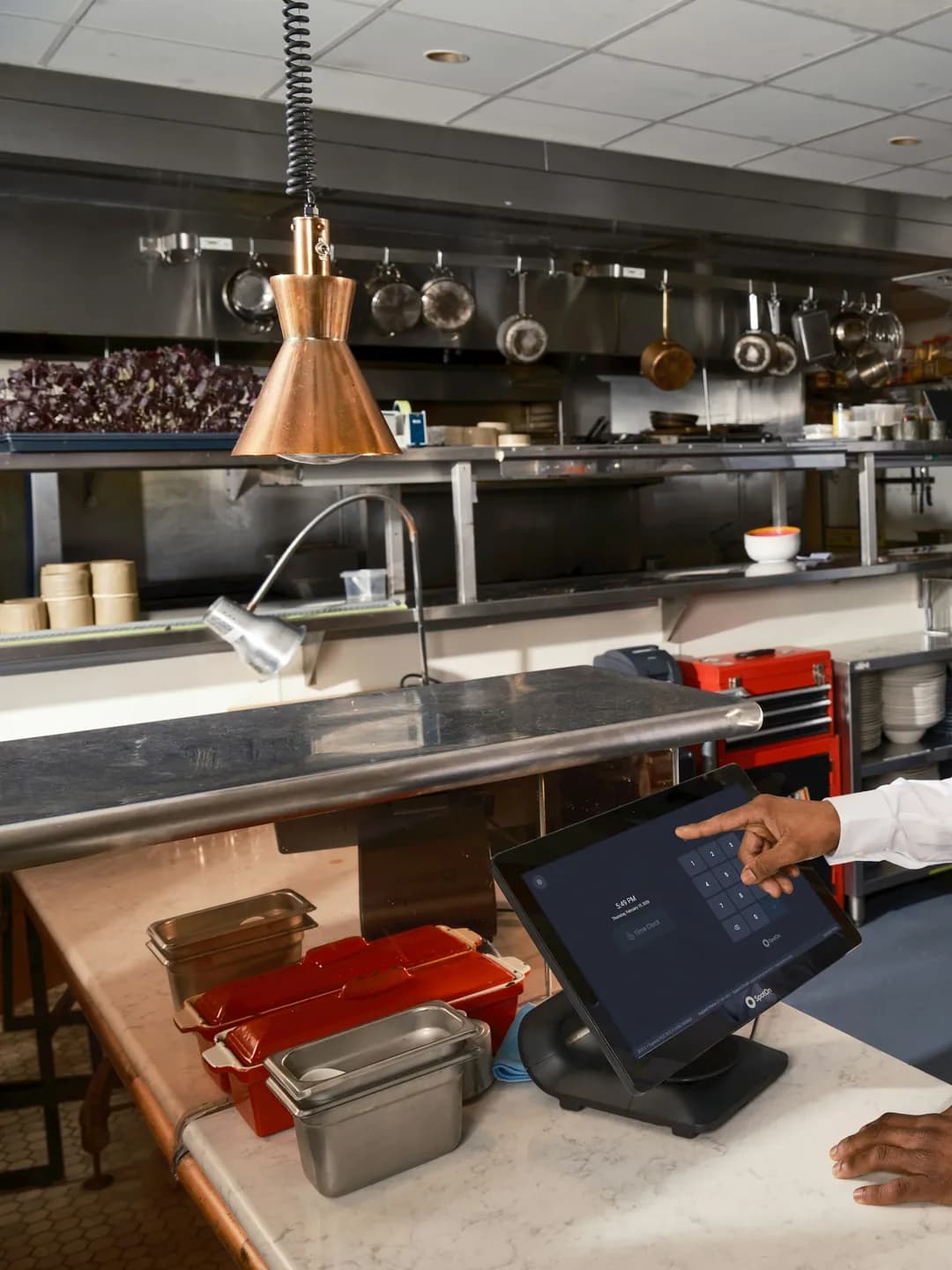 A technician working on a commercial cooking line during a scheduled visit